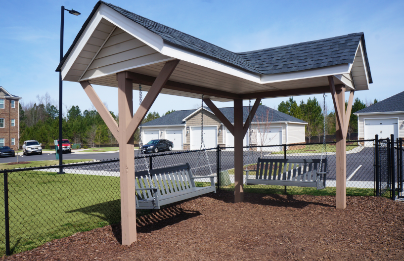 a picnic area with benches and a roofed pavilion