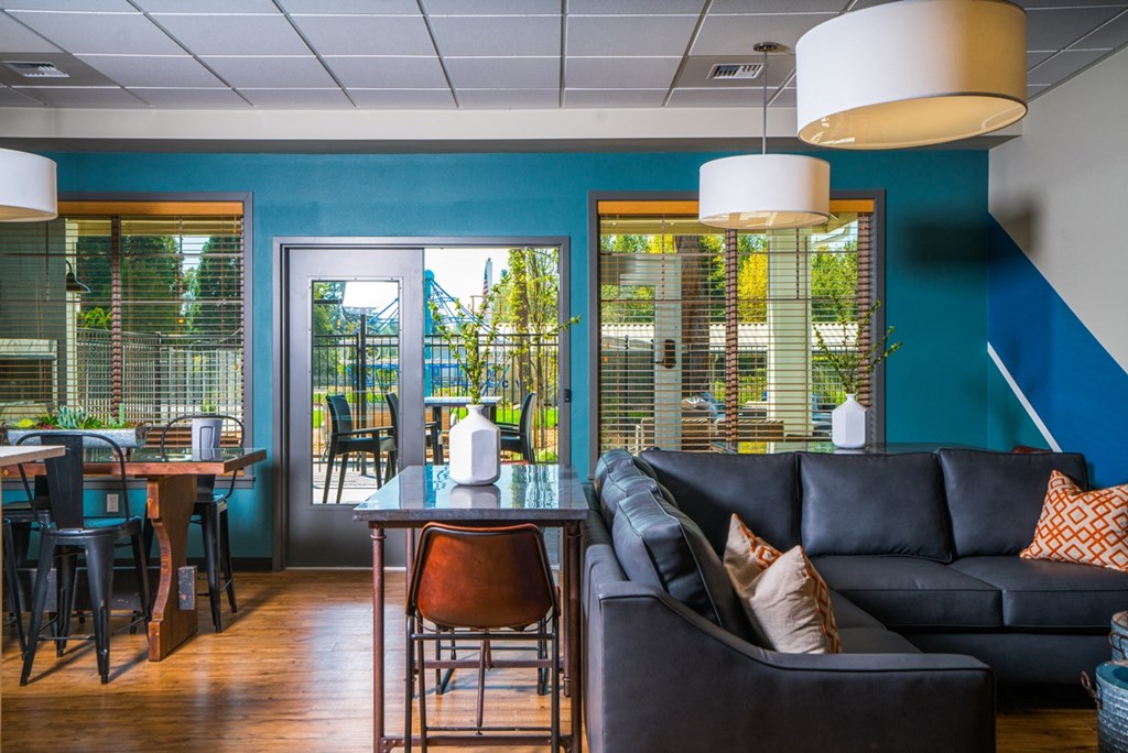 a living room with blue walls and a table with chairs