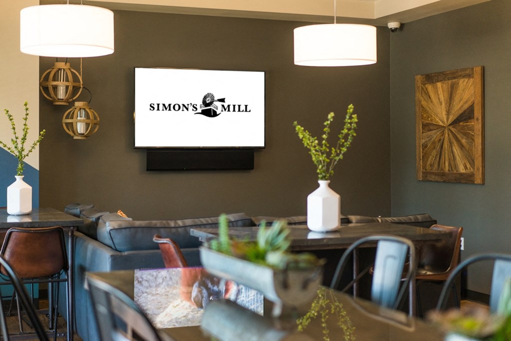 a dining room with tables and chairs and a tv on the wall
