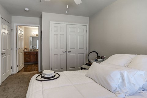 a bedroom with a bed and a hat on it