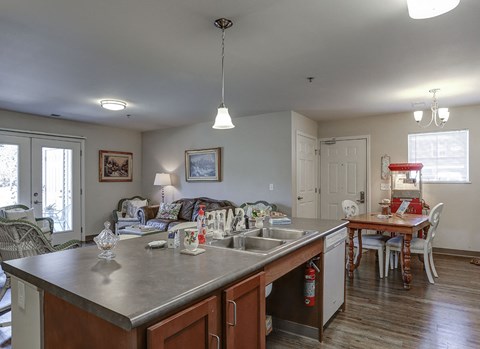 a kitchen with an island and a living room