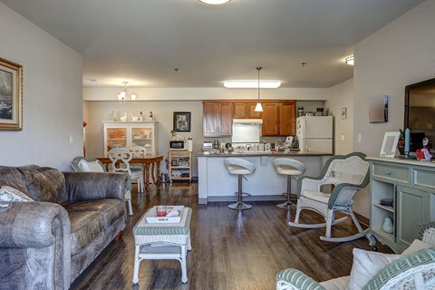 a living room and kitchen with a couch and a table