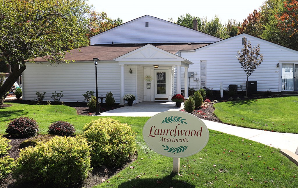 a white house with a yard sign in front of it