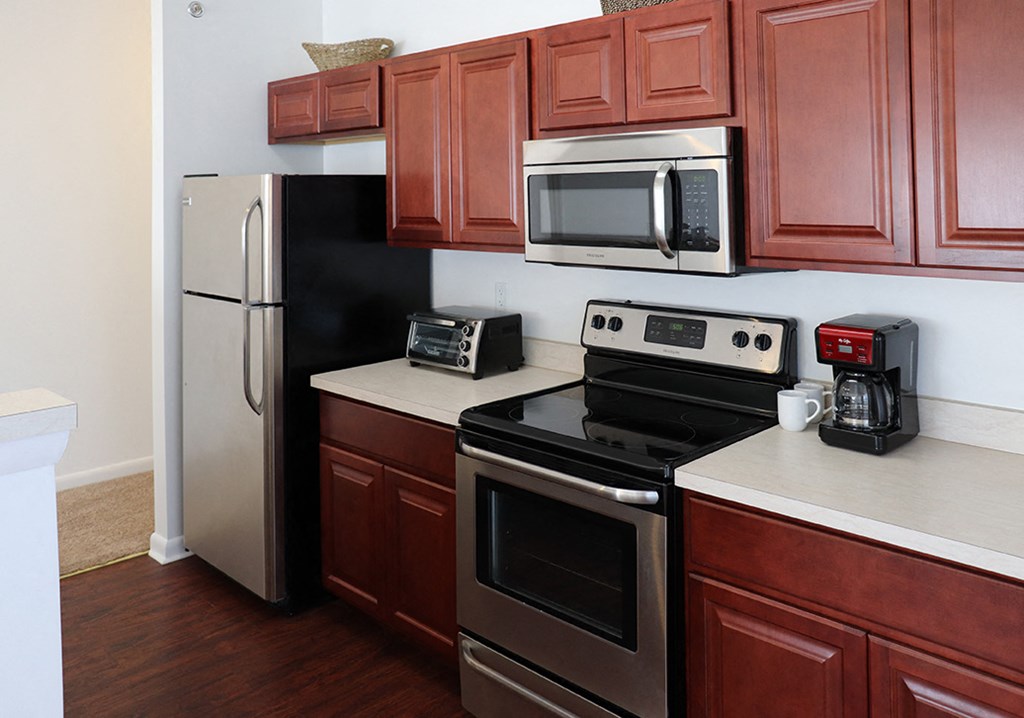 a kitchen with stainless steel appliances and wooden cabinets