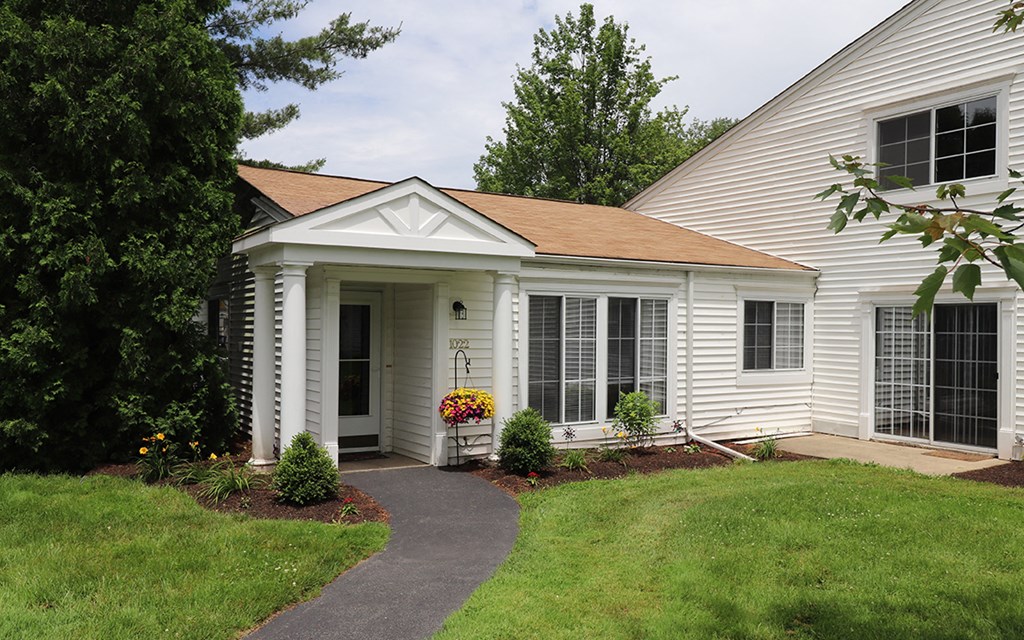 a white house with a front porch and a walkway