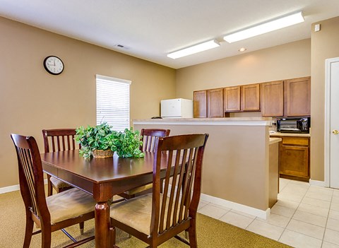 a dining room with a table and chairs next to a kitchen