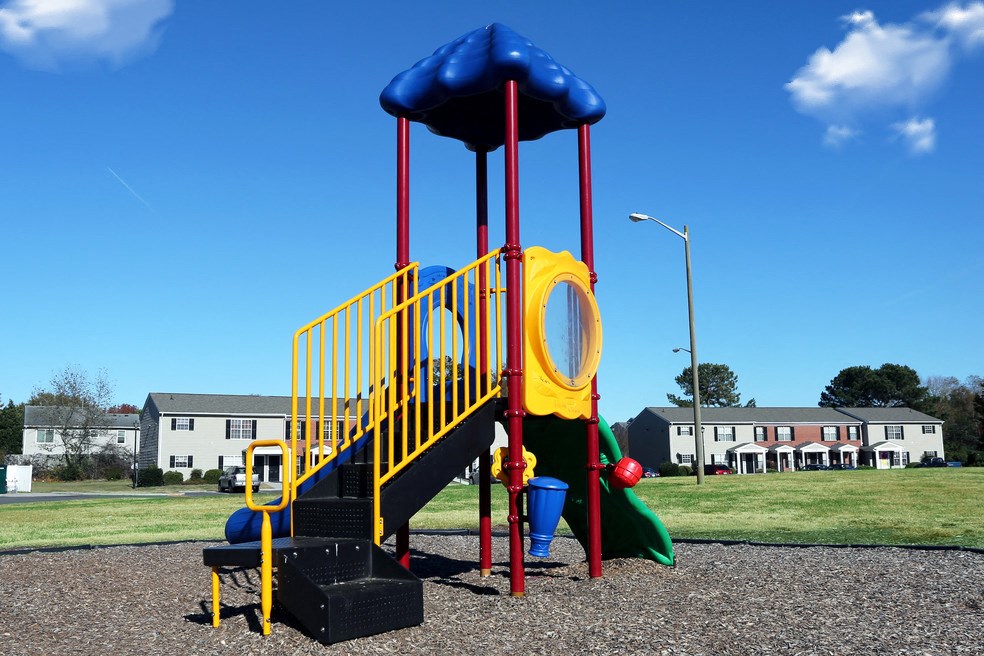 a playground with a blue and yellow play set