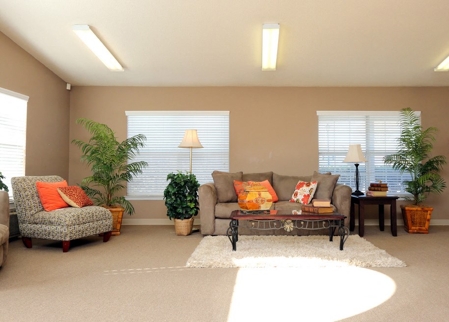 a living room with a couch and chairs and a table