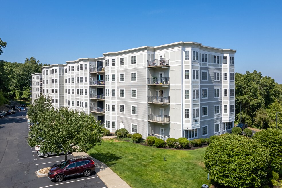 an aerial view of an apartment building with a car parked in front of it