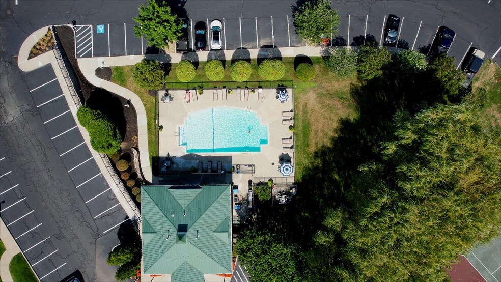 a birds eye view of a swimming pool in a parking lot