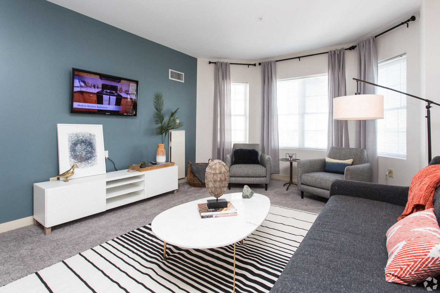 a living room with blue walls and a white coffee table