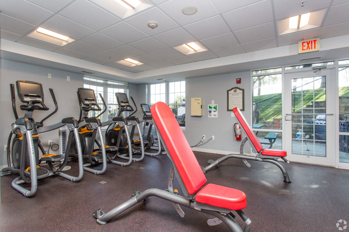 a gym with various exercise bikes and chairs in it
