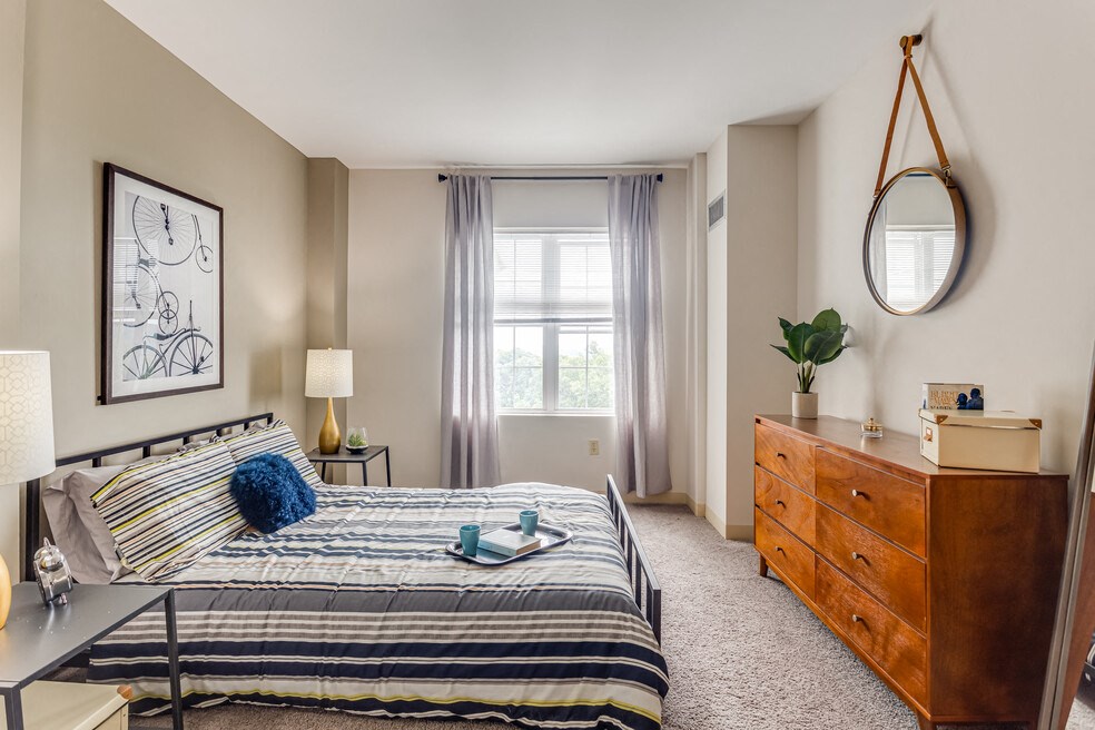 a bedroom with a bed and a dresser and a window