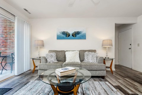 a living room with a couch and a glass coffee table