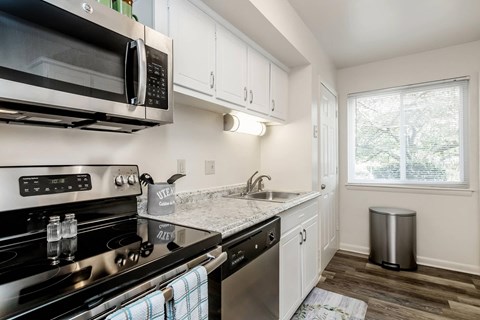 a kitchen with stainless steel appliances and a window