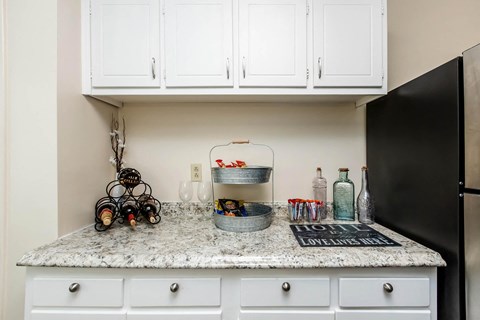 a kitchen with white cabinets and a counter top