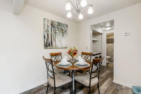a dining room with a table and chairs and a chandelier