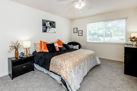 a bedroom with a bed and a window