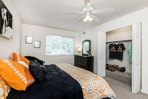 a bedroom with a bed and a ceiling fan