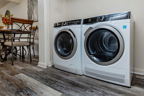 a front loading washer and dryer in a laundry room