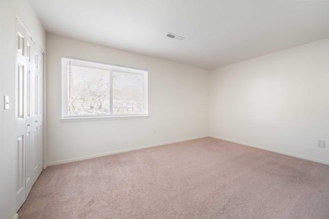 a white room with a window and a door