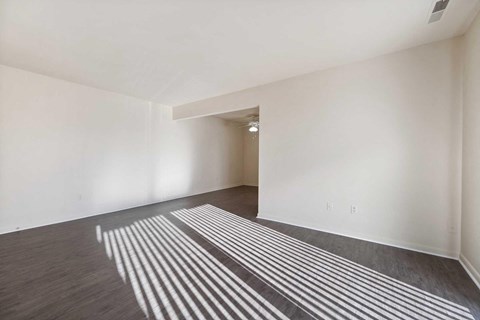 a living room with white walls and a striped rug