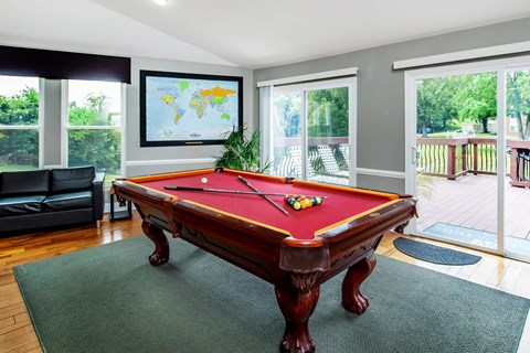 a pool table in a living room with a tv