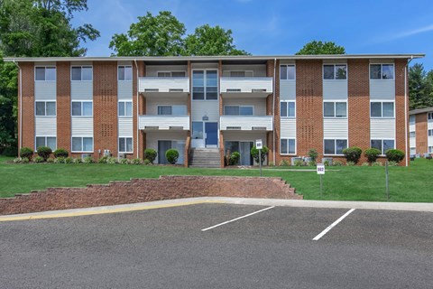 an apartment building with a lawn in front of it