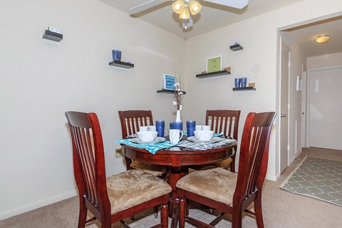 a dining room with a table and chairs