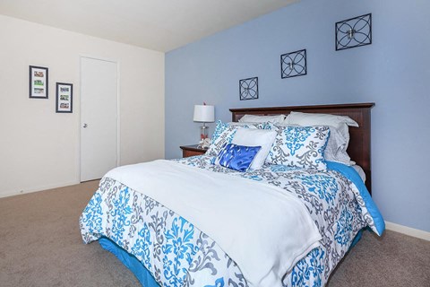 a blue and white bedroom with a bed