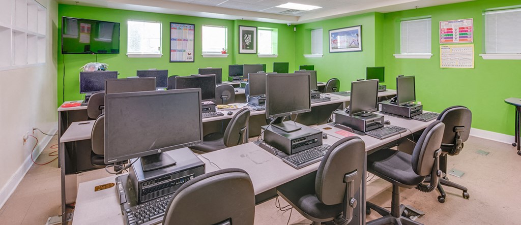 a classroom with a bunch of computers and desks in it