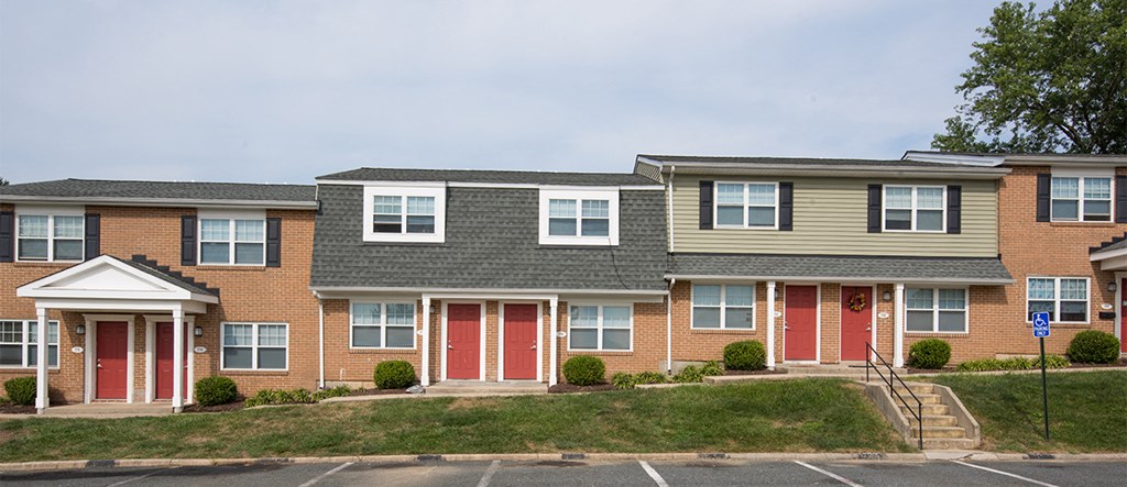 a row of town houses with red doors