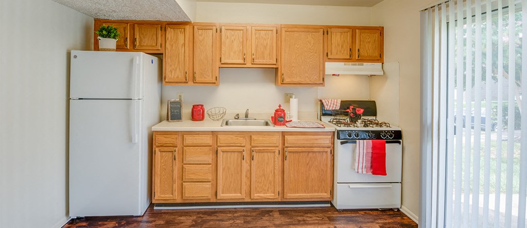 a kitchen with wooden cabinets and a white refrigerator