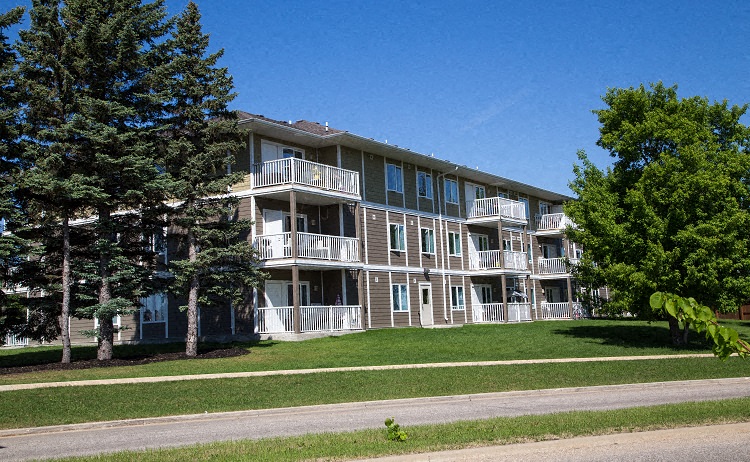 an apartment building on the side of a road