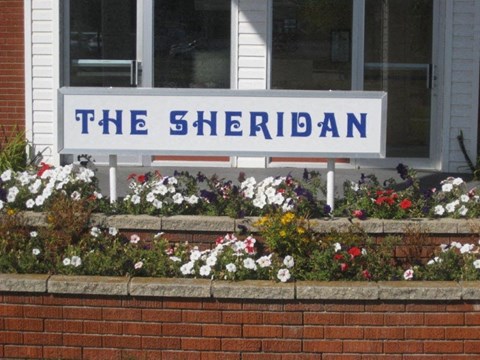 a sign in front of flowers
