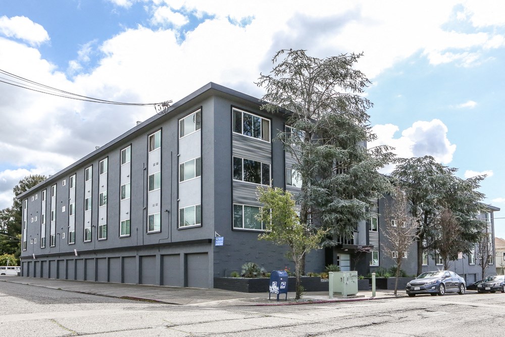 a large grey building on the corner of a street