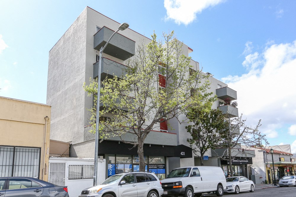 a city street with cars parked in front of a building
