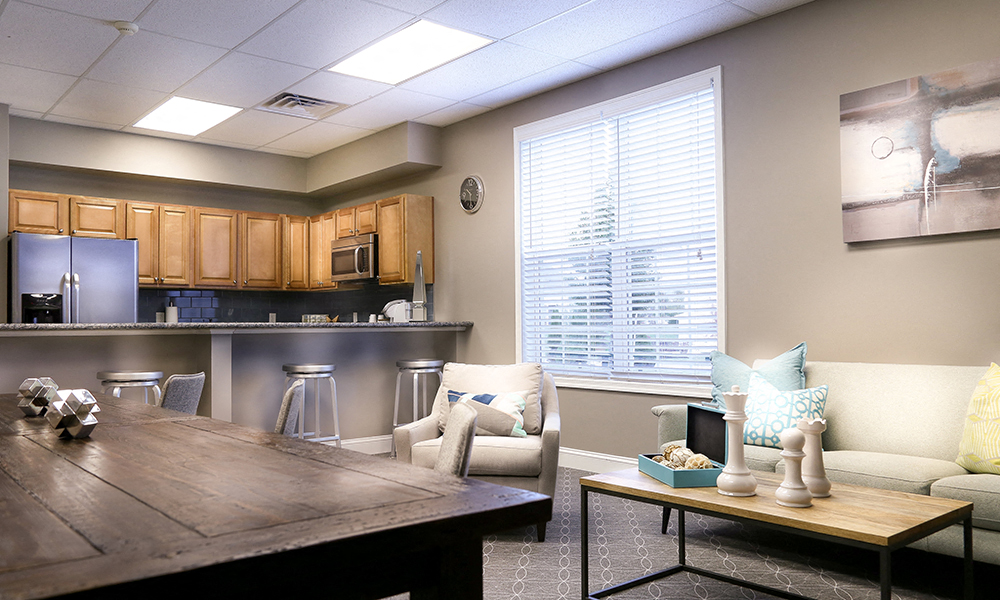 a living room with a kitchen and a table