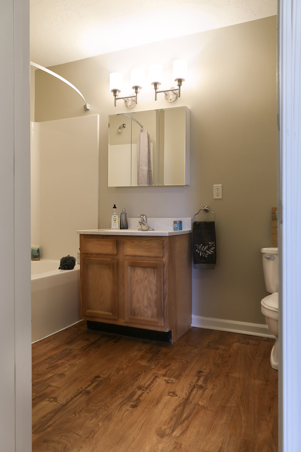 a bathroom with a sink and a toilet and a mirror
