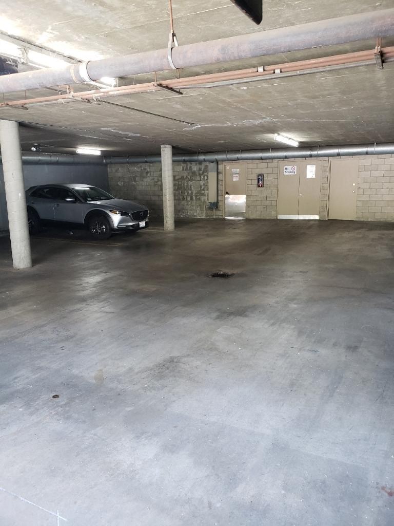 a parking garage with a car parked in it