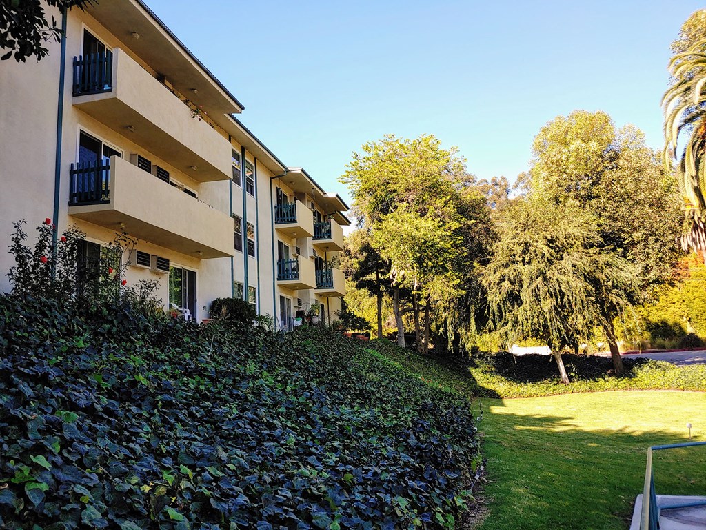 a building with a lawn and trees in front of it