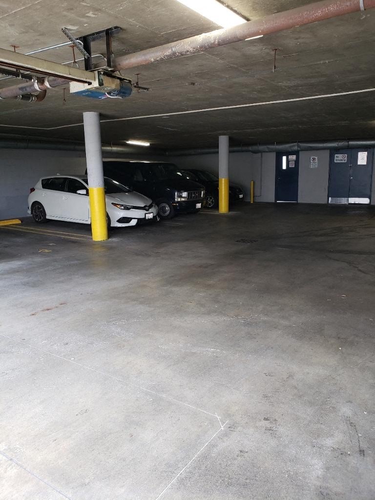 three cars parked in a parking garage