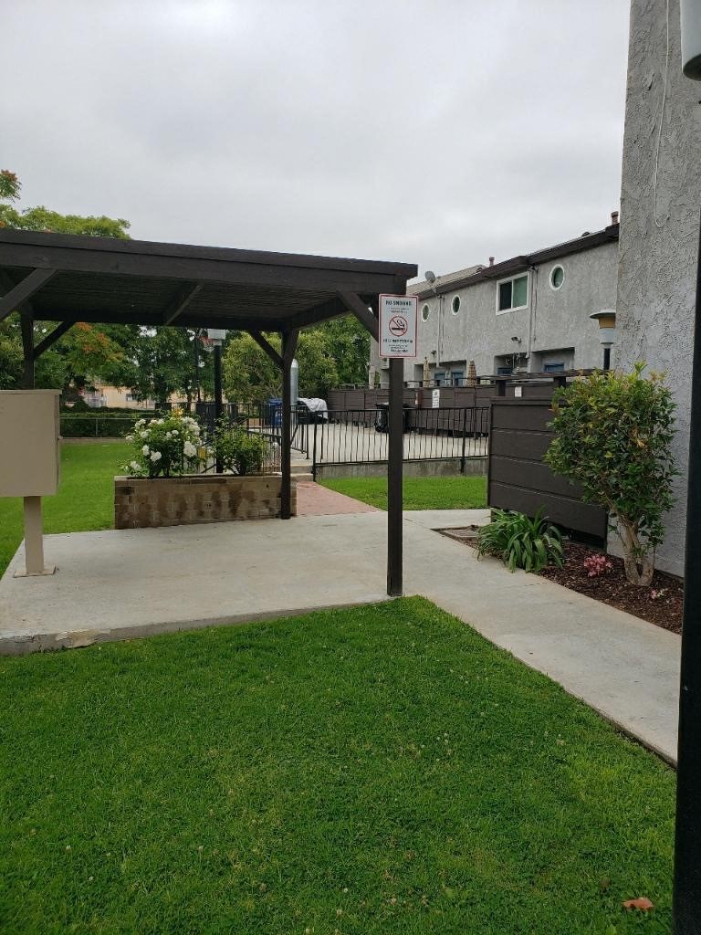 a patio with a no parking sign in the grass