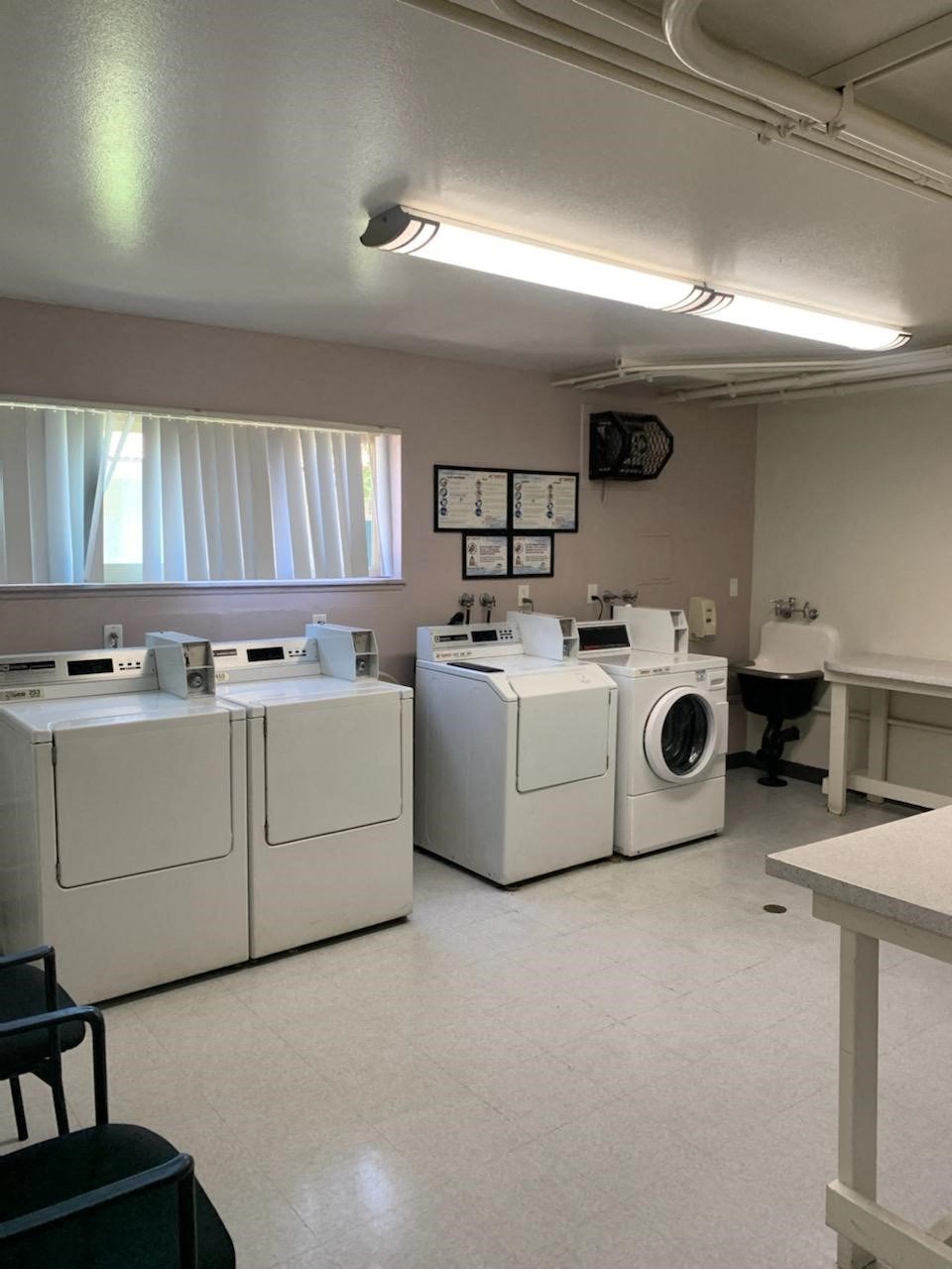 a laundry room with four washes and a washing machine