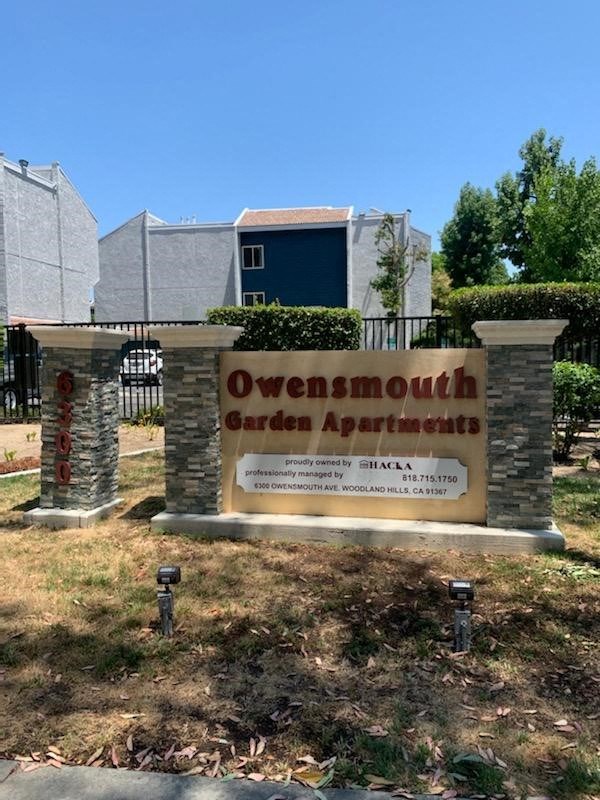 a sign for the owensmouth garden apartment building