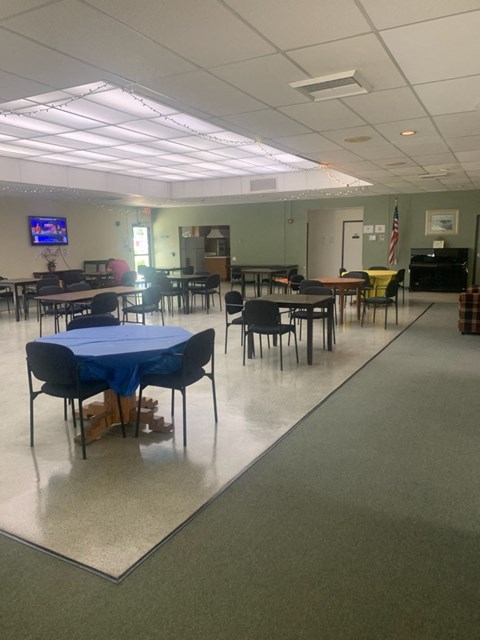 a dining room with tables and chairs and a tv