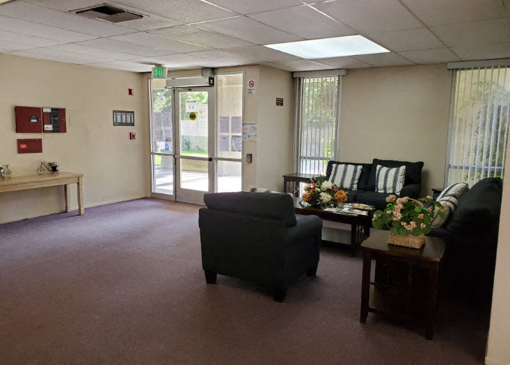 a living room with couches and chairs and a door
