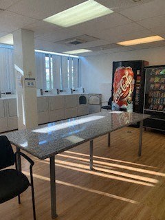 a dining room with a table and a coke machine