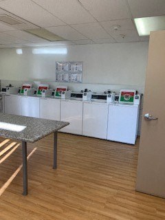 a room with a table and some washing machines