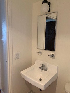 a bathroom with a white sink and a mirror